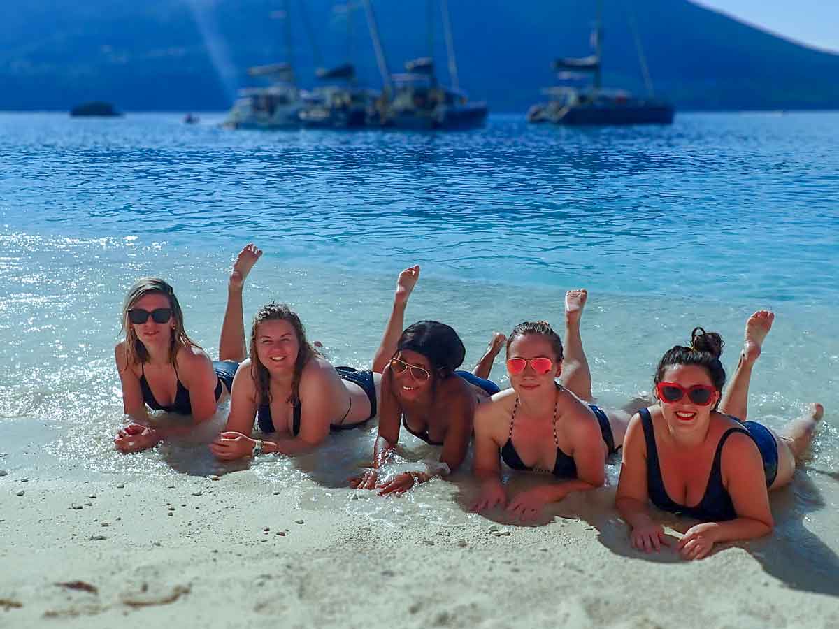 Four girls on beach on the university sail week